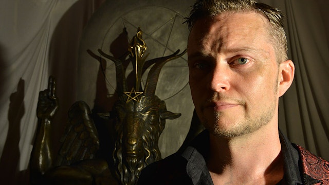 SALEM, MA - JULY 25: Lucien Greaves, spokesman for The Satanic Temple, with a statue of Baphomet at the group's meeting house in Salem, MA. The Satanic Temple, a group of political activists who identify themselves as a religious sect, are seeking to establish After-School Satan clubs as a counterpart to fundamentalist Christian Good News Clubs, which they see as the Religious Right to infiltrate public education, and erode the separation of church and state. (Photo by Josh Reynolds for The Washington Post via Getty Images)