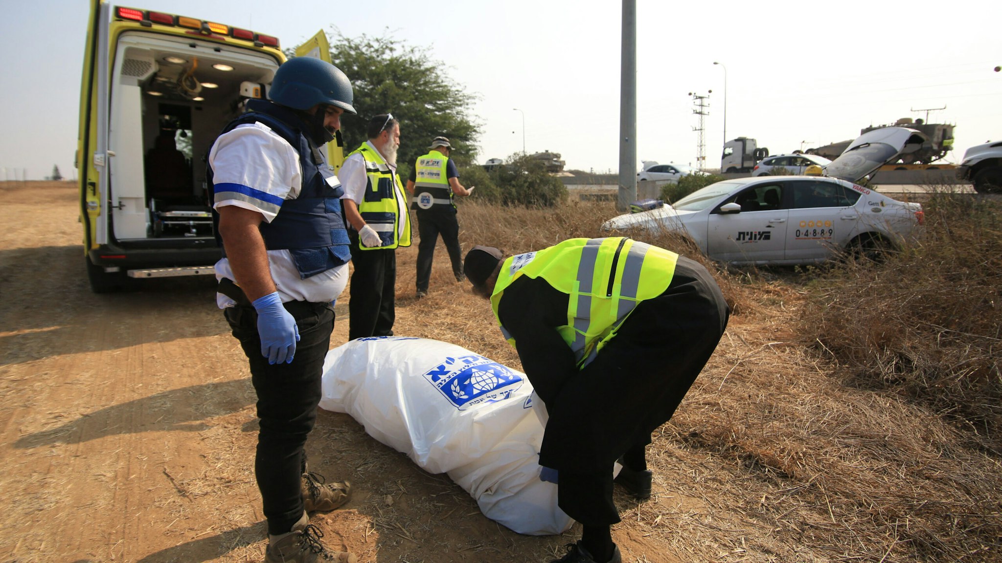 SDEROT, ISRAEL: Police officers carry a body bag as they find a dead body in a car after Hamas launched Operation Al-Aqsa Flood in Sderot, Israel on October 08, 2023. The death toll of Israelis has risen to 600, Israeli media reported.