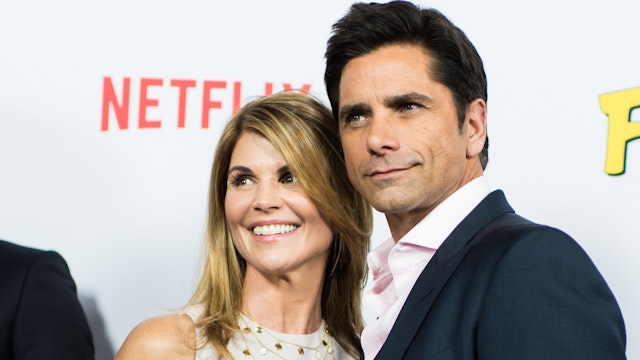Actor John Stamos (R) and actress Lori Loughlin attend the premiere of Netflix's 'Fuller House' at Pacific Theatres at The Grove on February 16, 2016 in Los Angeles, California.