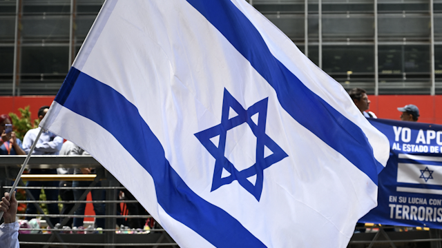 A man waves an Israeli national flag during a rally in support of the people of Israel in Bogota on October 9, 2023.