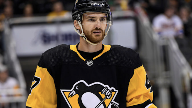 Pittsburgh Penguins Left Wing Adam Johnson (47) looks on during the second period in the NHL game between the Pittsburgh Penguins and the Colorado Avalanche on October 16, 2019, at PPG Paints Arena in Pittsburgh, PA.