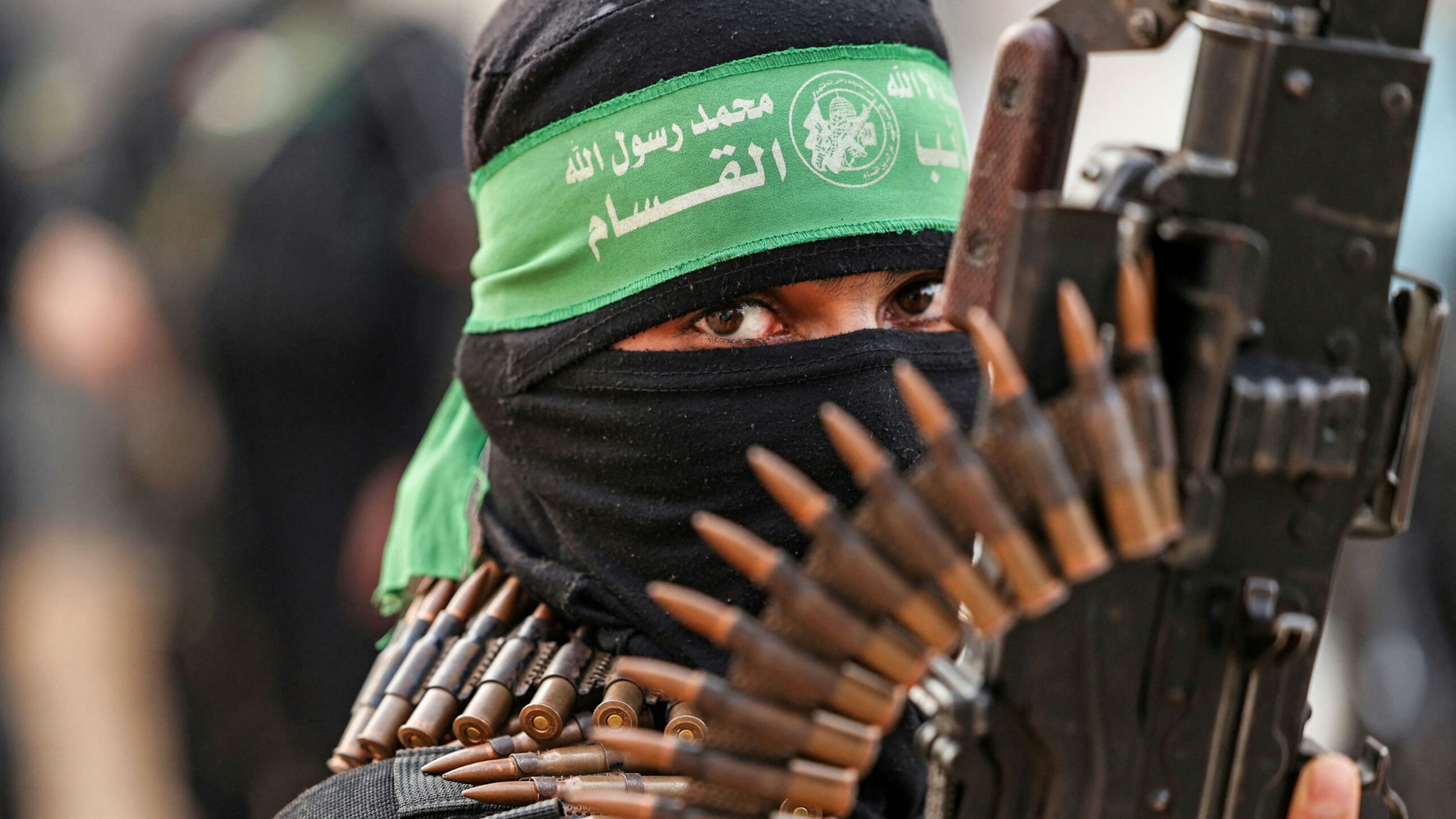 TOPSHOT - A member of Ezzedine al-Qassam Brigades, military wing of the Palestinian Hamas movement, takes part in a parade in Gaza City on November 14, 2021.