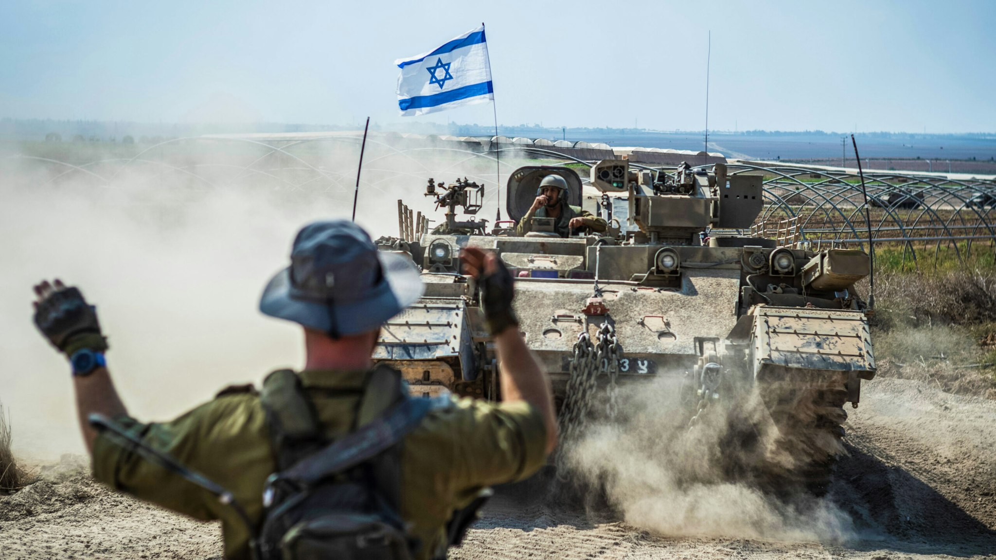 14 October 2023, Israel, Sderot: Israeli military combat vehicles and tanks are seen near the Israeli-Gaza border as fighting between Israeli troops and the militants of the Palestinian group Hamas continues.