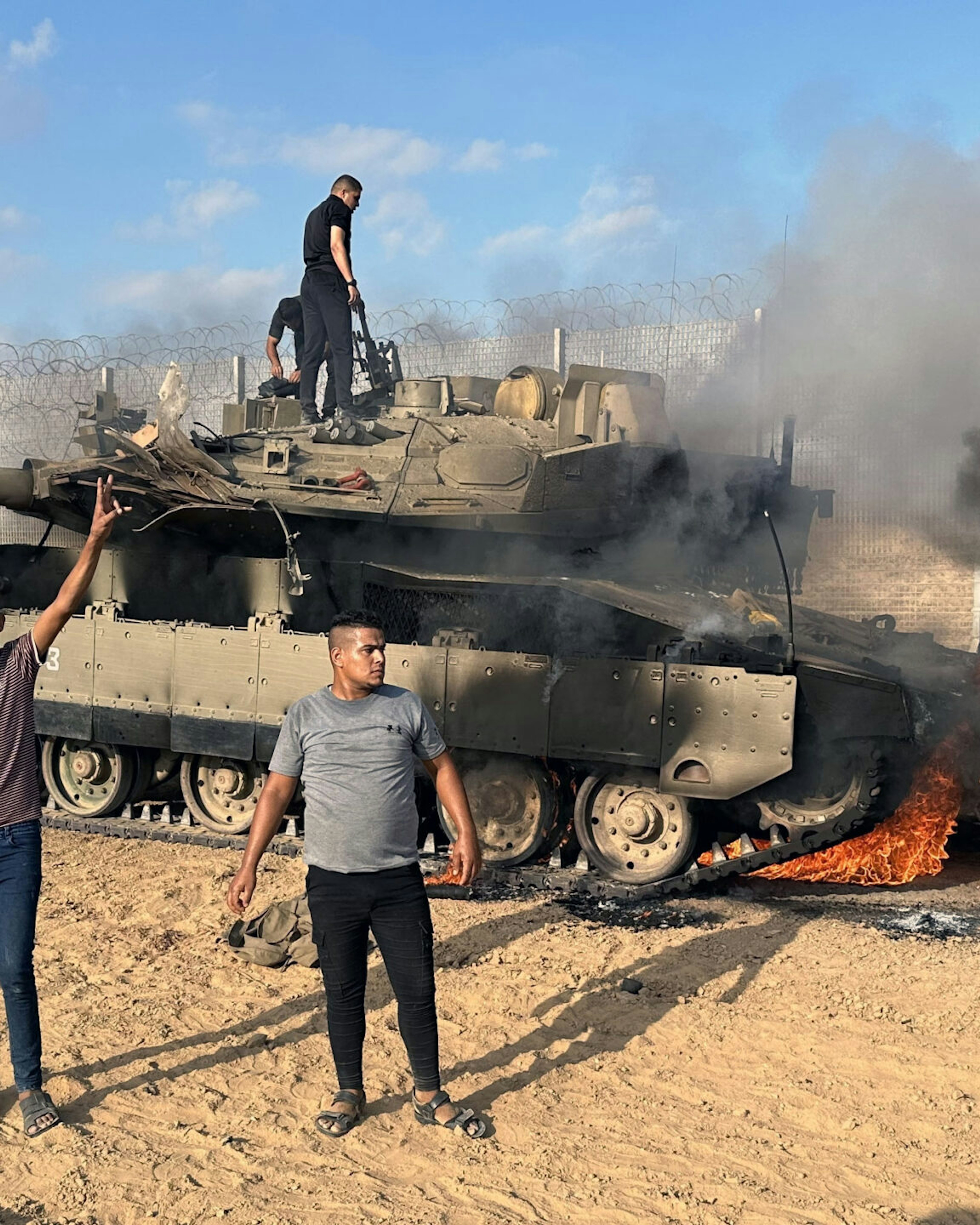 GAZA CITY, GAZA - OCTOBER 07: Smoke rises after Palestinian members of the Ezz Al-Din Al Qassam Brigades, the military wing of Hamas burn military armored vehicle belonging to Israeli forces near Gaza Strip, Gaza on October 07, 2023.