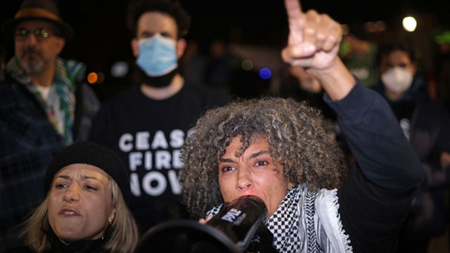 WASHINGTON, DC - NOVEMBER 15: Protesters shout slogans outside the headquarters of the Democratic National Committee during a demonstration against the war between Israel and Hamas on November 15, 2023 on Capitol Hill in Washington, DC. Jewish Voice for Peace and If Not Now held a candlelight vigil to call for a ceasefire in the Israel-Hamas war. (Photo by Alex Wong/Getty Images)