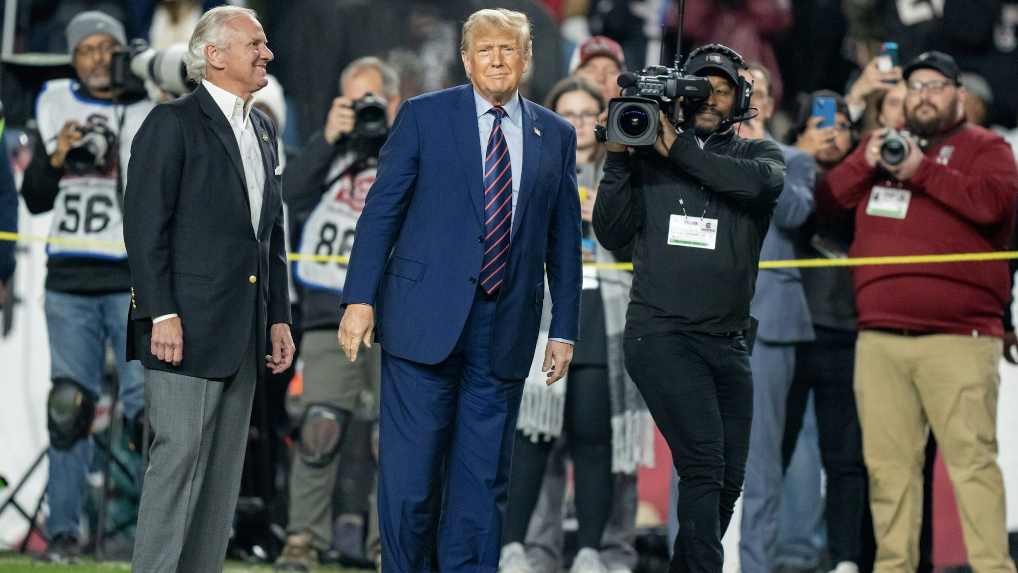 COLUMBIA, SOUTH CAROLINA - NOVEMBER 25: (L-R) South Carolina governor Henry McMaster and former U.S. President Donald Trump make an appearance on the field at halftime during the game between the South Carolina Gamecocks and the Clemson Tigers at Williams-Brice Stadium on November 25, 2023 in Columbia, South Carolina.