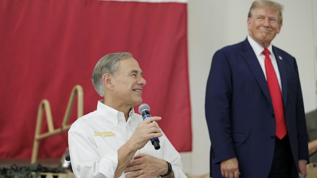 EDINBURG, TEXAS - NOVEMBER 19: Texas Governor Greg Abbott gives remarks with Former President Donald Trump at the South Texas International airport on November 19, 2023 in Edinburg, Texas. Trump and Abbott served meals to Texas National Guard and Texas DPS Troopers that are stationed at the U.S.-Mexico border over the Thanksgiving holiday.