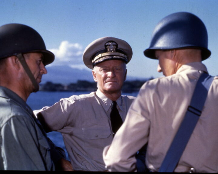 American military commander Admiral (and later Fleet Admiral) Chester William Nimitz (1885 - 1966) discusses strategy for the Gilbert and Marshall Islands campaign with two unidentified others, Pearl Harbor, Hawaii, October 1943. (Photo by PhotoQuest/Getty Images)