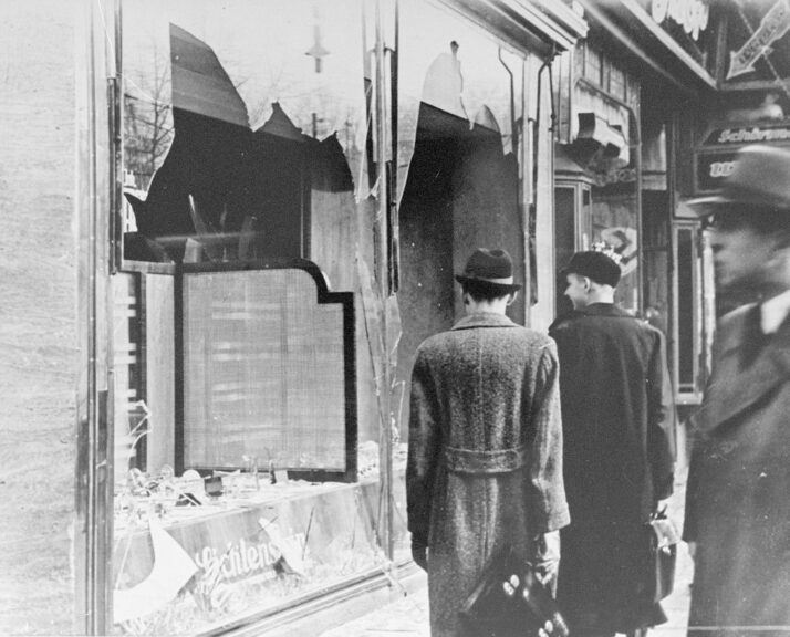 Germans pass by the smashed windows of a Jewish-owned shop. The aftermath of Kristallnacht (Night of Broken Glass) 9-10 November 1938, the German anti-semitic pogrom , when over 200 Synagogues were destroyed and thousands of Jewish homes and businesses were ransacked. (Photo by Universal History Archive/Getty Images)