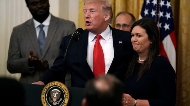 WASHINGTON, DC - JUNE 13: U.S. President Donald Trump speaks as White House Press Secretary Sarah Sanders listens during an East Room event on “second chance hiring” June 13, 2019 at the White House in Washington, DC. President Trump announced that Sanders will be leaving her position at the White House.