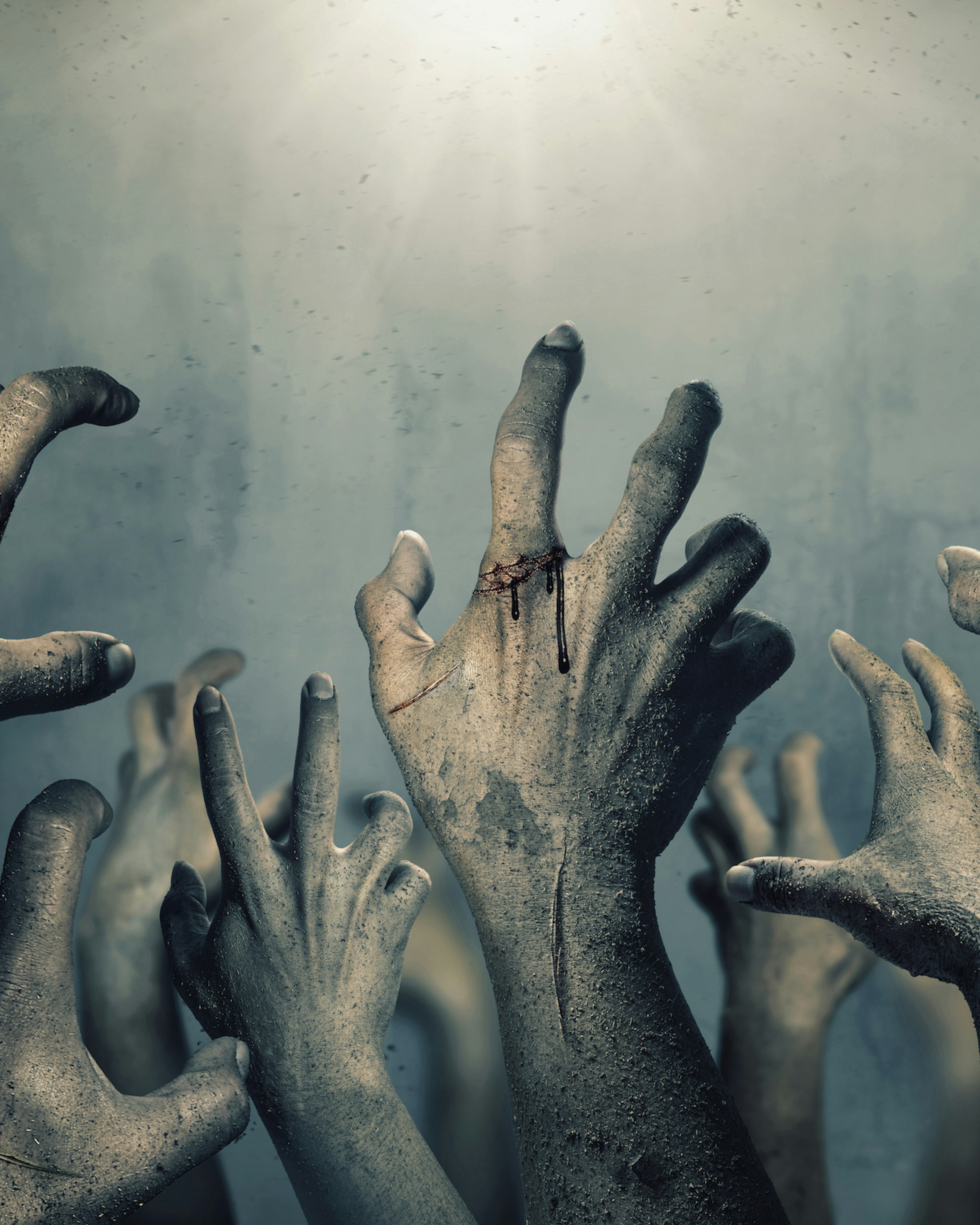 Zombie hands rising in dark Halloween night. chaiyapruek2520. Getty Images.