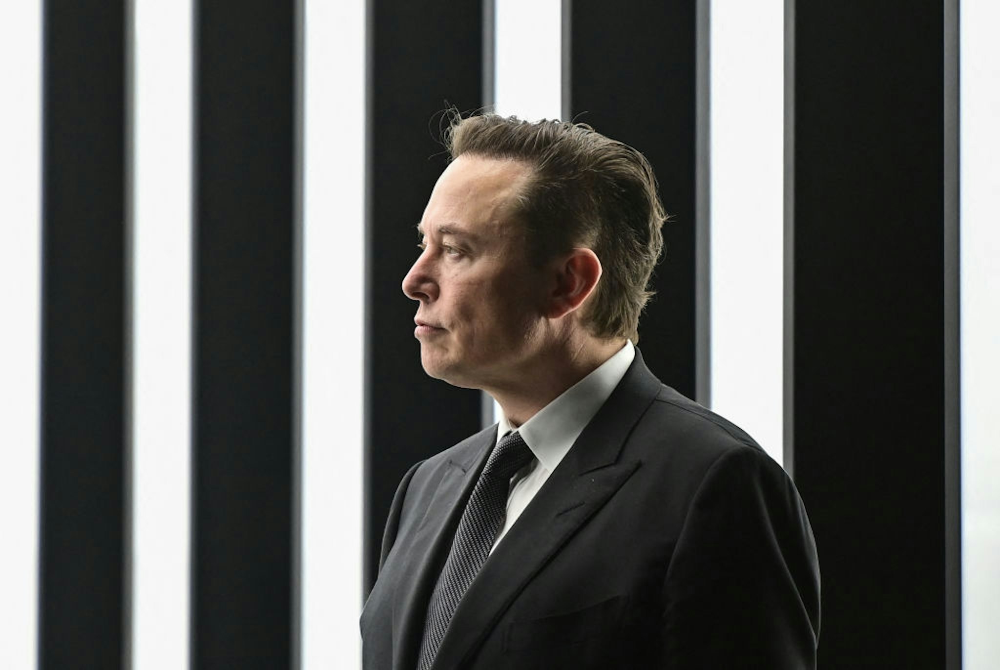 Tesla CEO Elon Musk is pictured as he attends the start of the production at Tesla's "Gigafactory" on March 22, 2022 in Gruenheide, southeast of Berlin. - US electric car pioneer Tesla received the go-ahead for its "gigafactory" in Germany on March 4, 2022, paving the way for production to begin shortly after an approval process dogged by delays and setbacks. (Photo by Patrick Pleul / POOL / AFP)