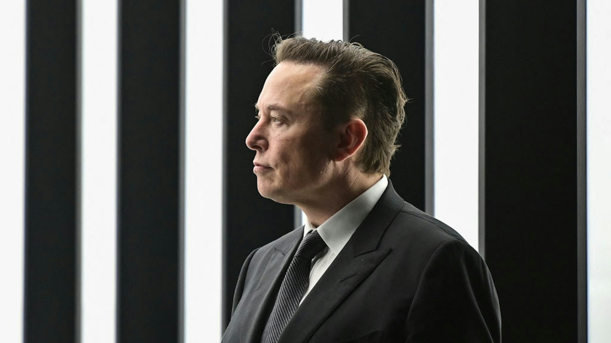 Tesla CEO Elon Musk is pictured as he attends the start of the production at Tesla's "Gigafactory" on March 22, 2022 in Gruenheide, southeast of Berlin. - US electric car pioneer Tesla received the go-ahead for its "gigafactory" in Germany on March 4, 2022, paving the way for production to begin shortly after an approval process dogged by delays and setbacks. (Photo by Patrick Pleul / POOL / AFP)