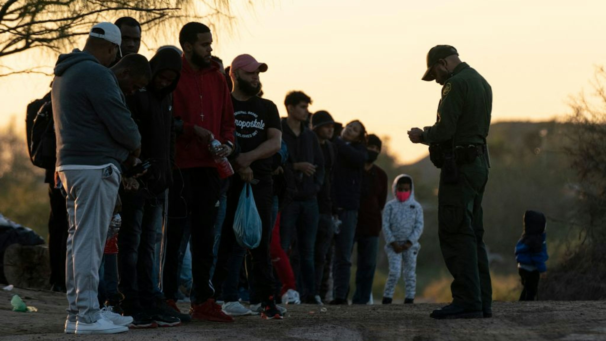 Migrants wait to be processed by Border Patrol agents in Eagle Pass, Texas on December 19, 2022. - The US Supreme Court halted December 19, 2022 the imminent removal of Title 42, a key policy used since the administration of president Donald Trump to block migrants at the southwest border, amid worries over a surge in undocumented immigrants. (Photo by VERONICA G. CARDENAS / AFP) (Photo by VERONICA G. CARDENAS/AFP via Getty Images)