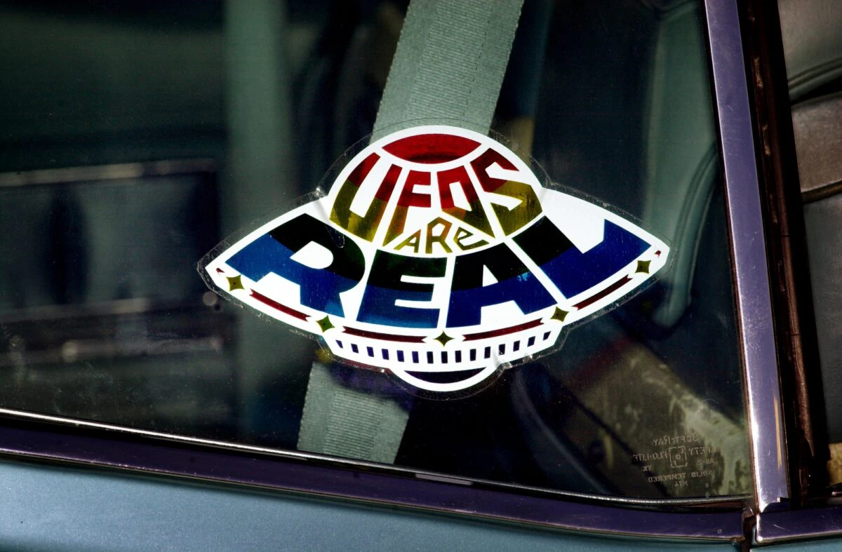 A sticker declares the existence of flying saucers from the window of a car parked on property near Jamul, CA, October 15, 2000, purchased by the Unarius Academy of Science to serve as a future landing site for "space brothers" from other planets.