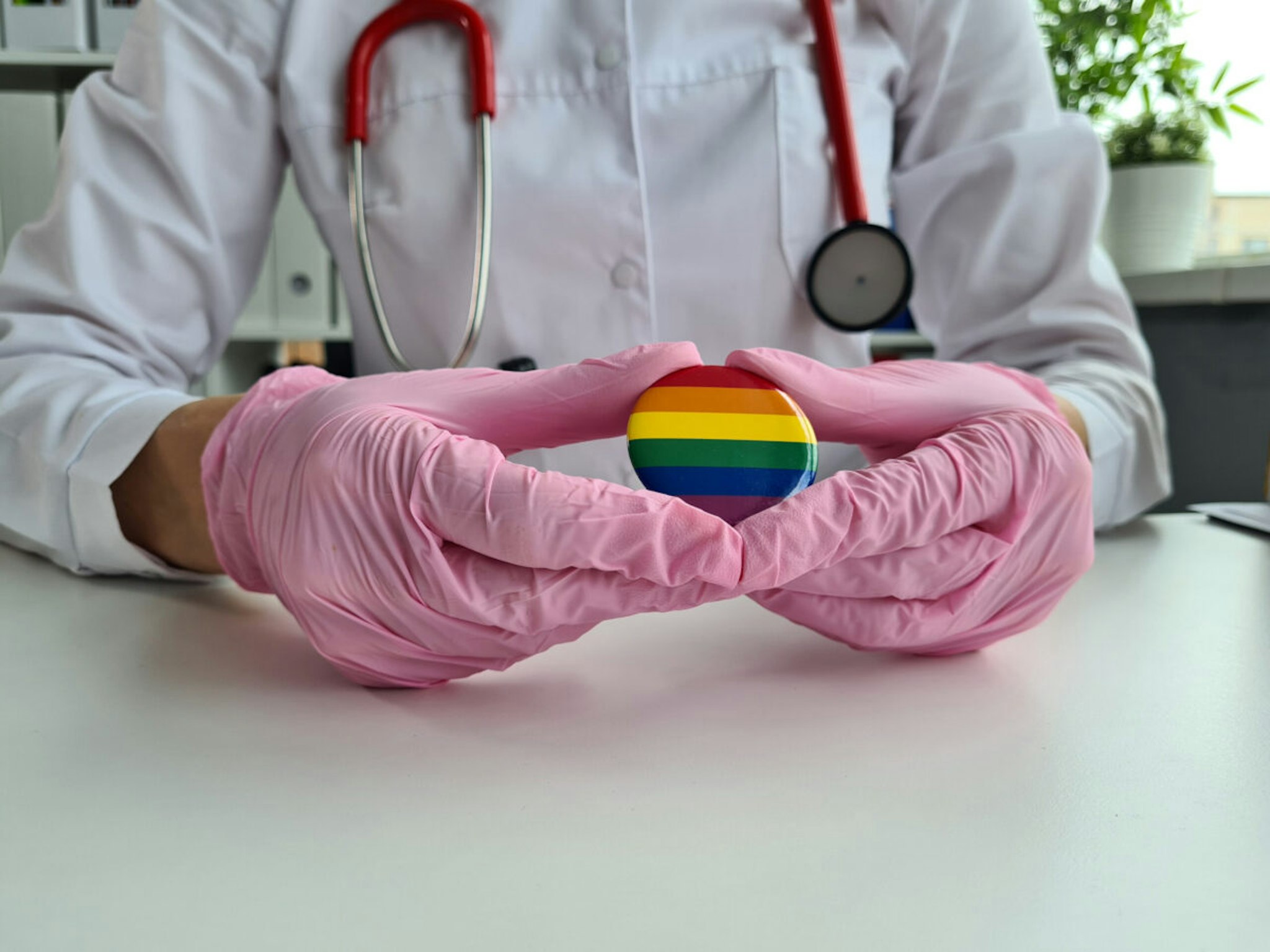 Health care lgbt and doctor holding lgbt badge. Treatment and rights for transgender and gay people
