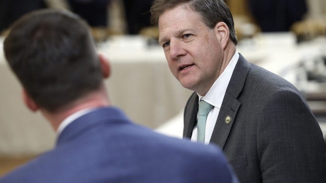 New Hampshire Governor Chris Sununu (R) waits for the start of a meeting between U.S. President Joe Biden and governors visiting from states around the country in the East Room of the White House on February 10, 2023 in Washington, DC.