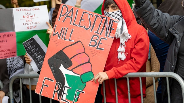 NEW YORK, UNITED STATES - 2023/10/12: Students from Brooklyn College and supporters hold signs during a pro-Palestinian demonstration at the entrance of the campus. The pro-Palestinian student organization Students for Justice In Palestine (SJP) held protests in colleges across the nation to show solidarity with Palestine. On October 7 the Palestinian militant group Hamas launched a large-scale surprise attack from Gaza, launching thousands of missiles and sending at least 1,500 fighters by land, sea and air into Israel. At least 1,300 Israelis have been confirmed killed and 150 kidnapped. 1,203 Palestinians in Gaza are also confirmed killed. The attack is prompting retaliatory strikes by Israel on Gaza and a declaration of war by the Israeli prime minister. (Photo by Michael Nigro/Pacific Press/LightRocket via Getty Images)