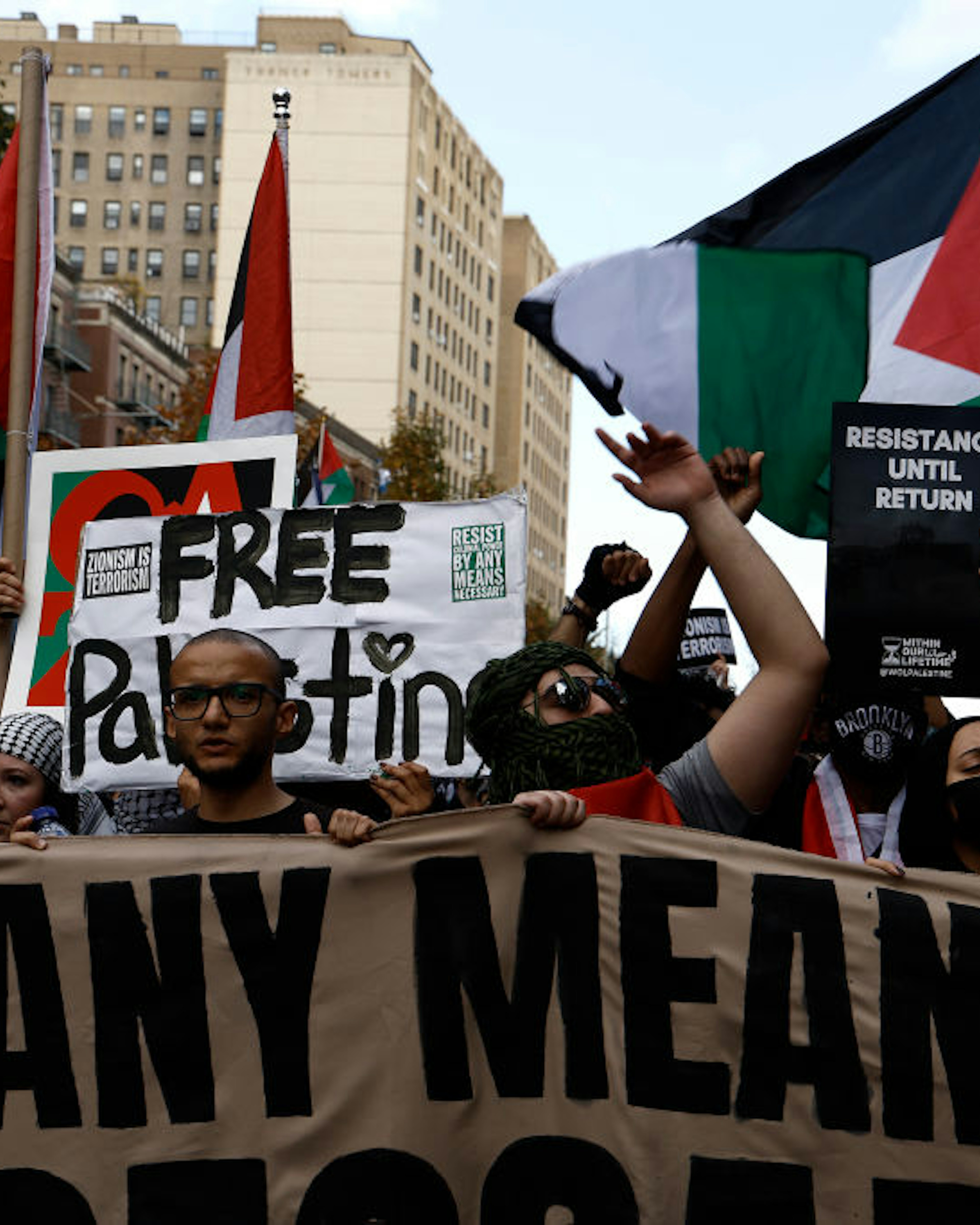 NEW YORK, NEW YORK - OCTOBER 28: Palestinian supporters chant slogans with flags during the “Flood Brooklyn For Gaza” rally as the threat of an Israeli invasion looms near, on October 28, 2023 in the Neighborhood of Crown Heights in Brooklyn a section of New York City. The two groups that organized the rally near the Chabad-Lubavitch Hasidic movement headquarters comes at the heels of demonstrator arrests a week earlier in Bay Ridge Brooklyn. Israeli Defense Forces have increased larger military incursions into Gaza purportedly as a “shaping operation” which sets the stage in preparation for a full scale invasion of Gaza. communications and electricity. (Photo by John Lamparski/Getty Images)