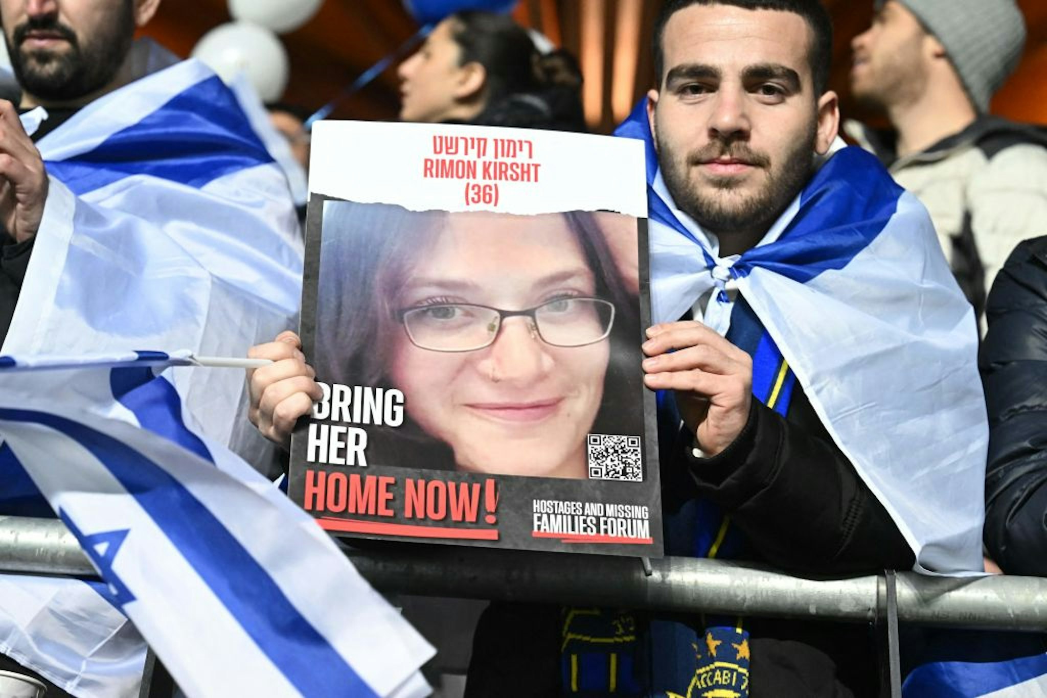 An Israel fan holds iup a placard calling for the release of Rimon Kirsht, one of the hostages held by Palestinian militants since the October 7 attack, prior to the UEFA Euro 2024 Group I qualification football match Israel v Switzerland at the Pancho Arena in Felcsut, west of Budapest, Hungary on November 15, 2023. (Photo by Attila KISBENEDEK / AFP) (Photo by ATTILA KISBENEDEK/AFP via Getty Images)
