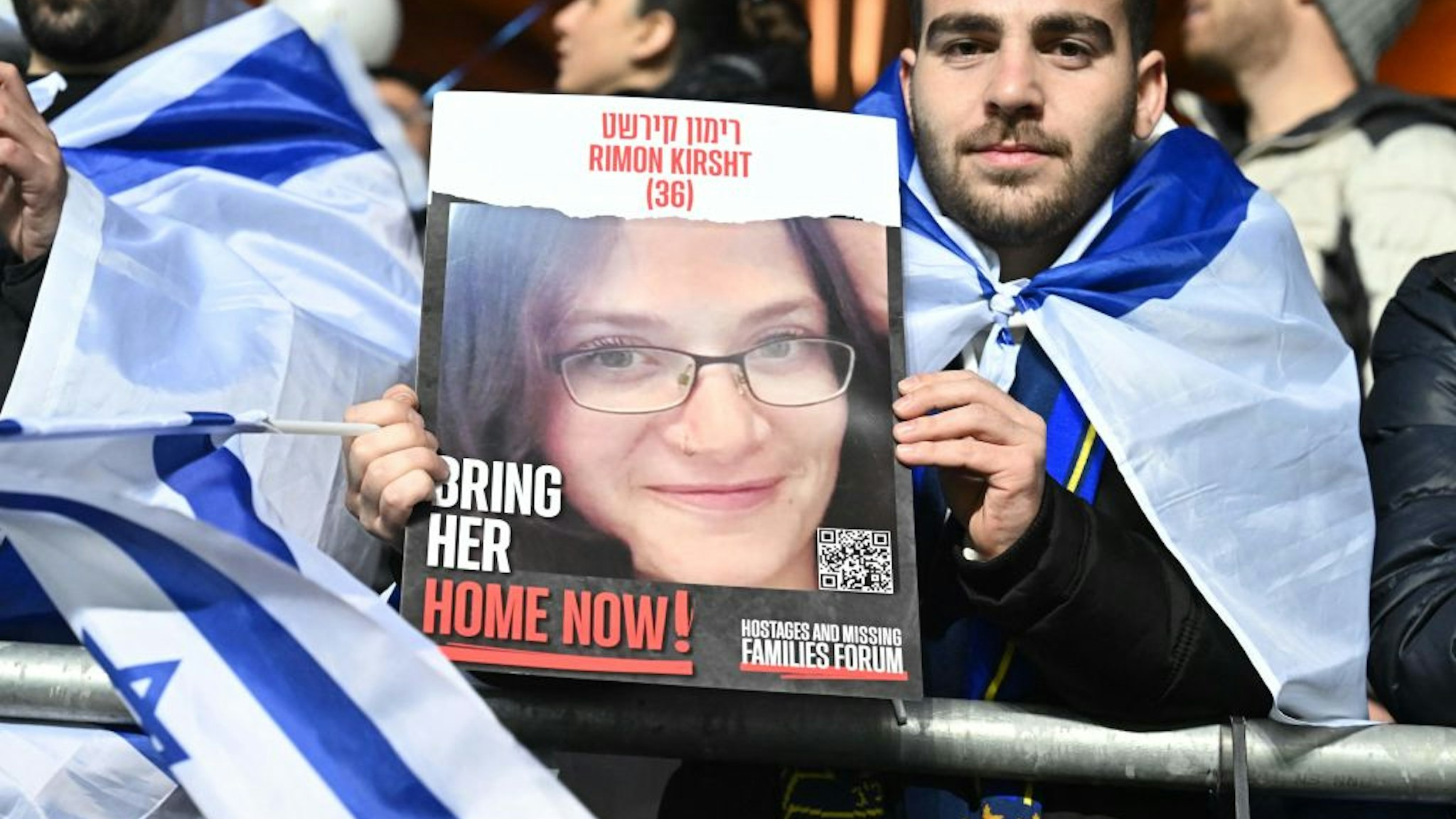 An Israel fan holds iup a placard calling for the release of Rimon Kirsht, one of the hostages held by Palestinian militants since the October 7 attack, prior to the UEFA Euro 2024 Group I qualification football match Israel v Switzerland at the Pancho Arena in Felcsut, west of Budapest, Hungary on November 15, 2023. (Photo by Attila KISBENEDEK / AFP) (Photo by ATTILA KISBENEDEK/AFP via Getty Images)