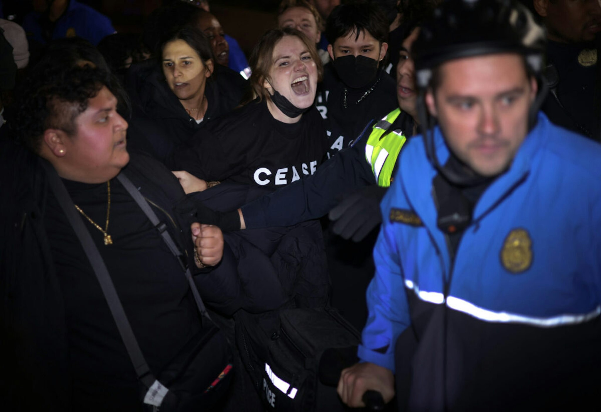 Protesters clash with members of U.S. Capitol Police as they block the entrance of the headquarters of the Democratic National Committee during a demonstration against the war between Israel and Hamas on November 15, 2023 on Capitol Hill in Washington, DC.