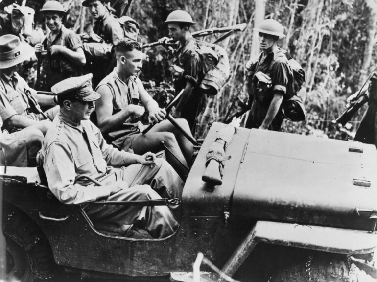 circa 1943: General MacArthur (1880 - 1964), Allied Commander in the Southwest Pacific area, passing a line of Australian troops moving up to the front in the New Guinea jungle whilst he is on a tour of inspection. (Photo by Three Lions/Getty Images)