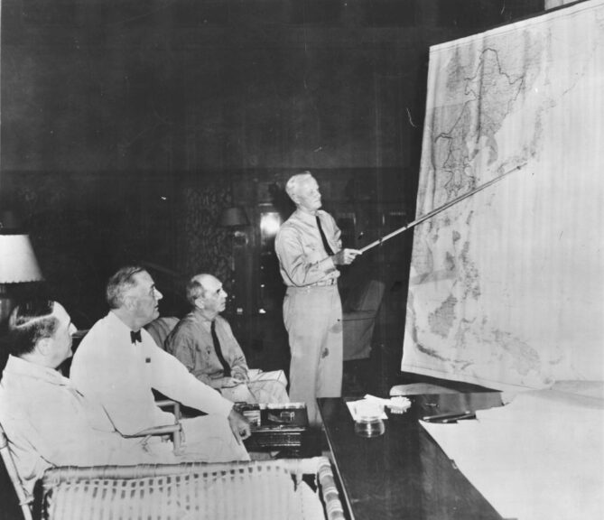 circa 1943: American General Douglas MacArthur (1880 - 1964), President Franklin Roosevelt (1882 - 1945), and Admiral William Leahy (1875 - 1959) at a briefing given by Admiral Chester Nimitz (1885 - 1966) at a map of the Pacific war zone. (Photo by Keystone Features/Getty Images)