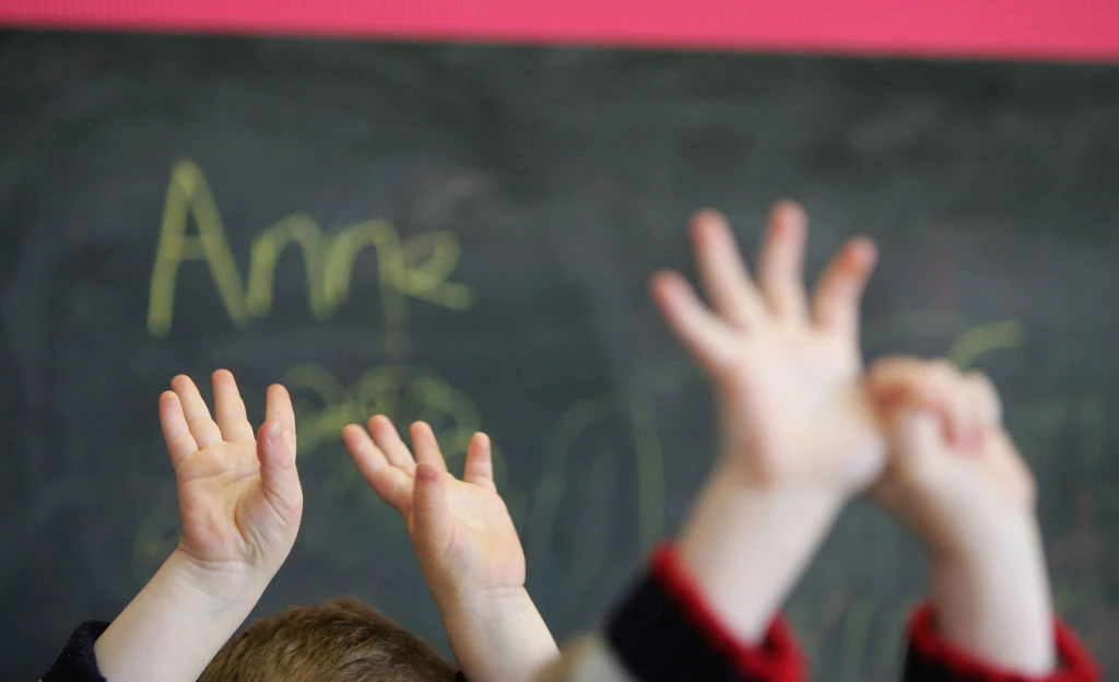 GLASGOW, SCOTLAND - JANUARY 28: Children wave their hands at a private nursery school January 28, 2005 in Glasgow, Scotland. The average price of pre-school care has increased over the past year, sending child care prices to an average of GBP200 in parts of the southeast. Many working parents in the UK have called for pre-school childcare subsidies such as those in France where nearly 100% of three-year-olds are in pre-school education, despite the fact that school attendance is not compulsory until they turn five. (Photo by Christopher Furlong/Getty Images)