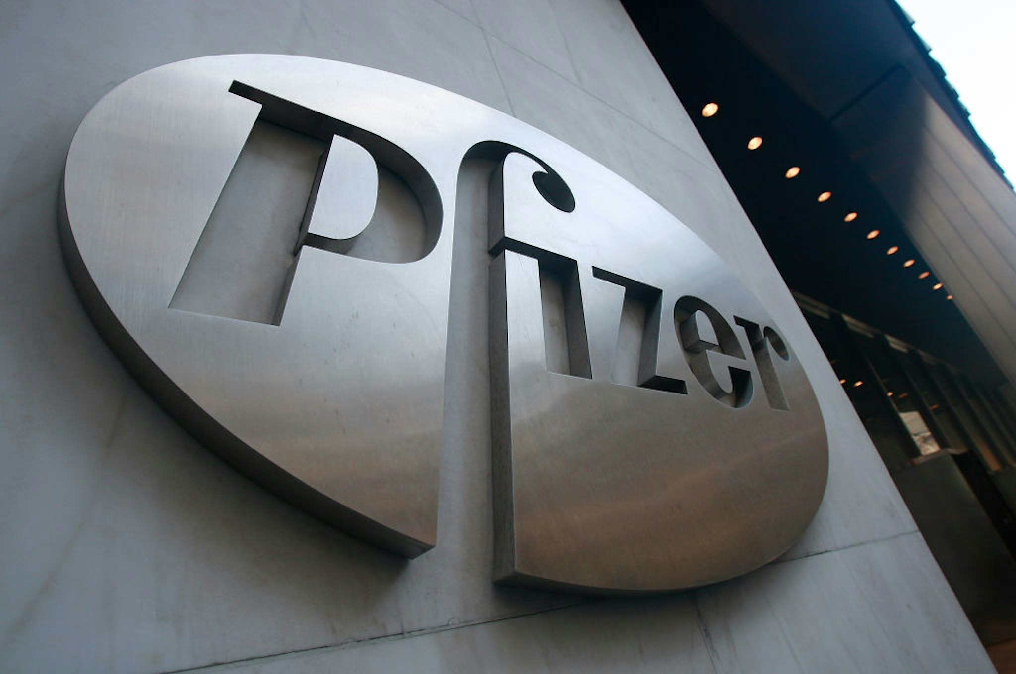 NEW YORK - JANUARY 26: A Pfizer sign hangs on the outside of their headquarters after a news conference discussing the planned merger of Pfizer and Wyeth January 26, 2009 in New York City. Pfizer plans to acquire Wyeth for $68 billion creating the world's largest biopharmaceutical company.