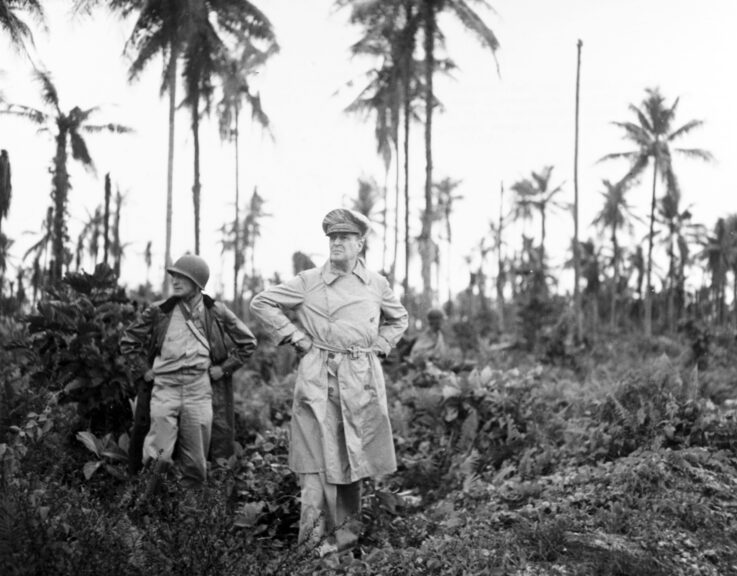 US military commander General Douglas MacArthur (1880 - 1964) (center) and his acting aide Colonel Lloyd Lehrabas inspect the results of the naval bombardment, Los Negros Island, Admiralty Islands, Papua New Guinea, February 29, 1944. (Photo by US Army Signal Corps/Interim Archives/Getty Images)