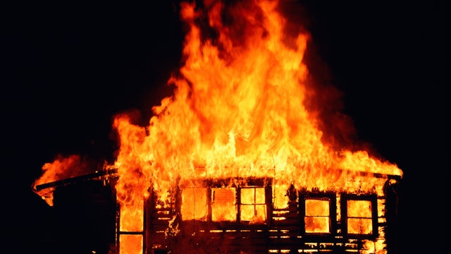 House on fire at night - stock photo