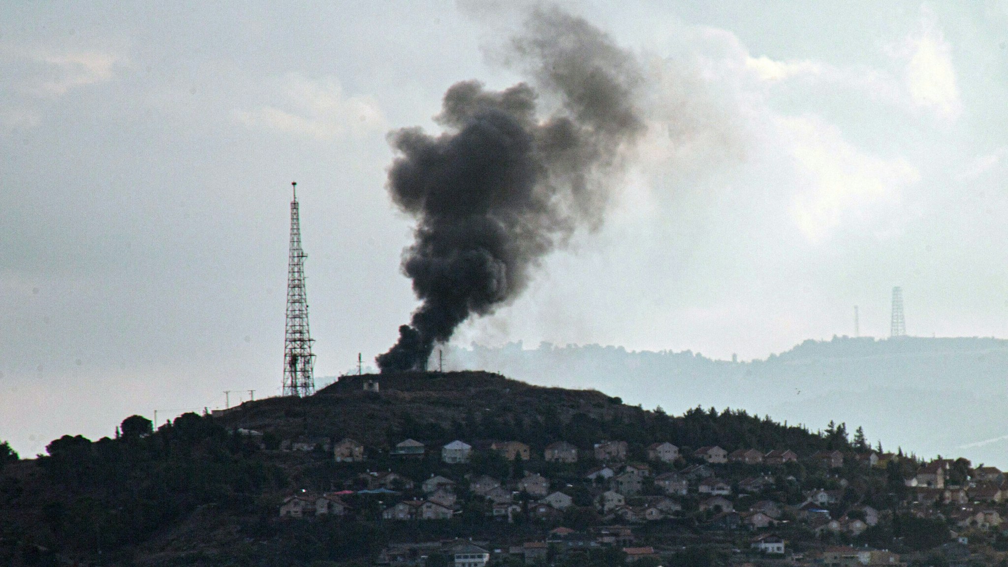 Smoke billows after an attack by the Shiite Muslim group Hezbollah on an Israeli military post in Metulla, facing the southern Lebanese border village of Khiam on November 17, 2023, amid increasing cross-border tensions as fighting continues with Hamas militants in the southern Gaza Strip.