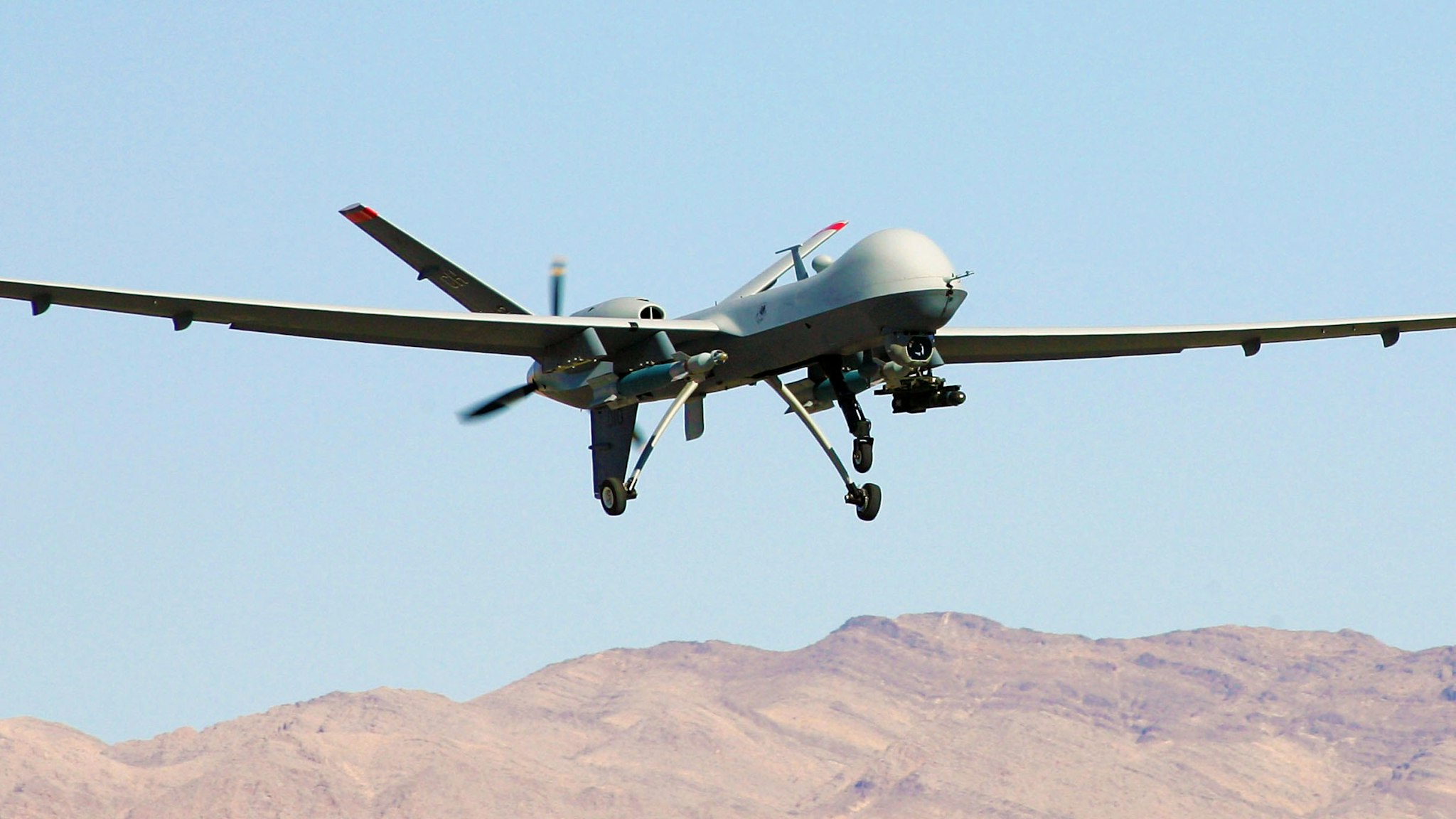 CREECH AIR FORCE BASE, NV - AUGUST 08: An MQ-9 Reaper takes off August 8, 2007 at Creech Air Force Base in Indian Springs, Nevada. The Reaper is the Air Force's first "hunter-killer" unmanned aerial vehicle (UAV), designed to engage time-sensitive targets on the battlefield as well as provide intelligence and surveillance. The jet-fighter sized Reapers are 36 feet long with 66-foot wingspans and can fly for up to 14 hours fully loaded with laser-guided bombs and air-to-ground missiles. They can fly twice as fast and high as the smaller MQ-1 Predators, reaching speeds of 300 mph at an altitude of up to 50,000 feet. The aircraft are flown by a pilot and a sensor operator from ground control stations. The Reapers are expected to be used in combat operations by the U.S. military in Afghanistan and Iraq within the next year.