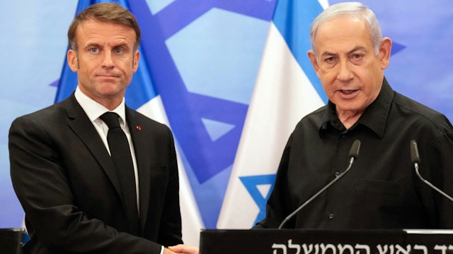 TOPSHOT - Israeli Prime Minister Benjamin Netanyahu (R) shakes hands with French President Emmanuel Macron (L) after their joint press conference in Jerusalem on October 24, 2023. Macron's visit comes more than two weeks after Hamas militants stormed into Israel from the Gaza Strip and killed at least 1,400 people, according to Israeli officials while Israel continues a relentless bombardment of the Gaza Strip and prepares for a ground offensive with more than 5,000 Palestinians, mainly civilians, killed so far across the Palestinian territory, according to the latest toll from the Hamas health ministry in Gaza.