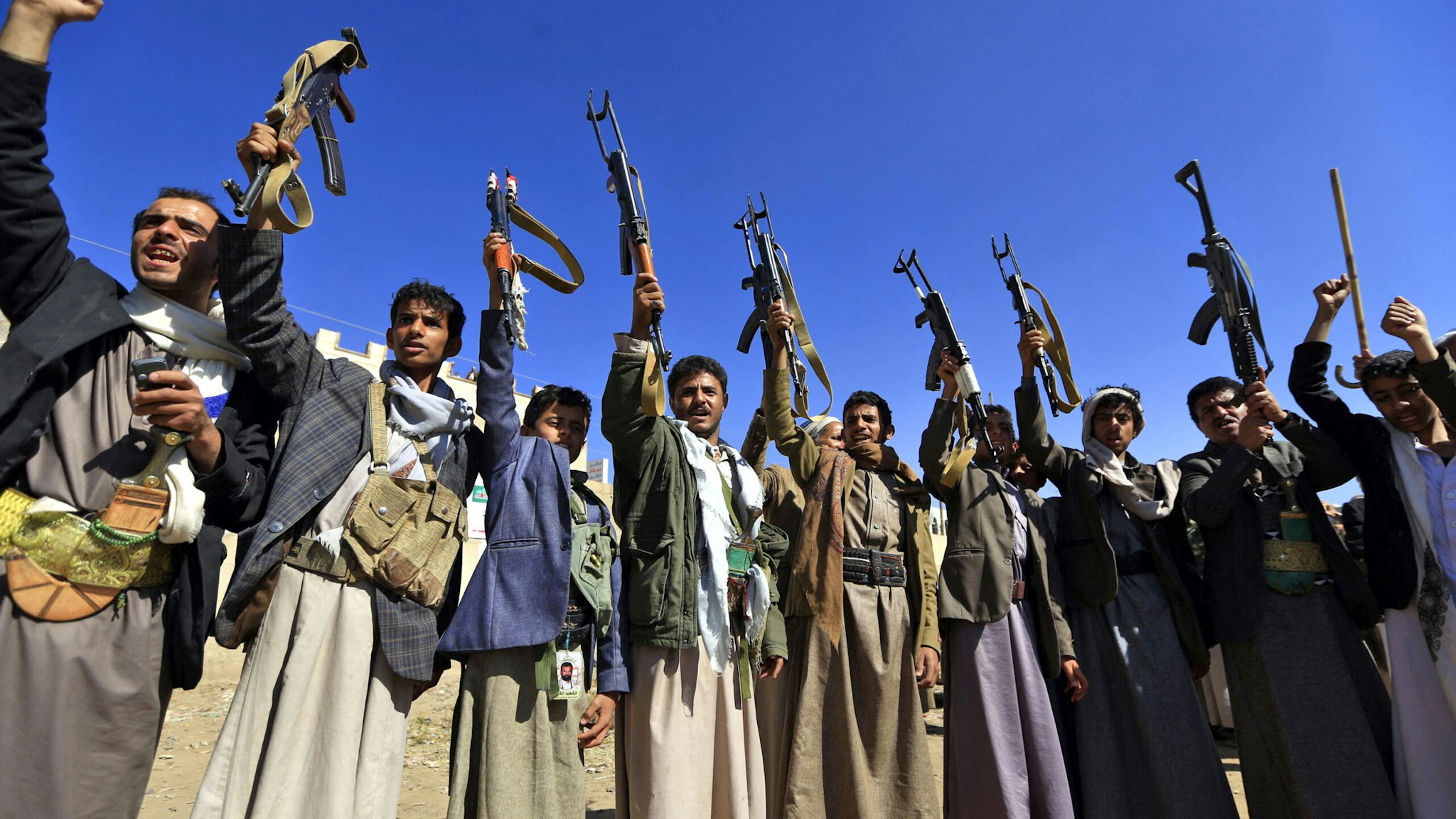 Armed Yemeni men brandish their weapons as they gather in the capital Sanaa to show their support to the Shiite Huthi movement against the Saudi-led intervention, on December 13, 2018. UN chief Antonio Guterres announced today a series of breakthroughs in talks with rivals in the Yemen conflict, including a ceasefire for a vital port.