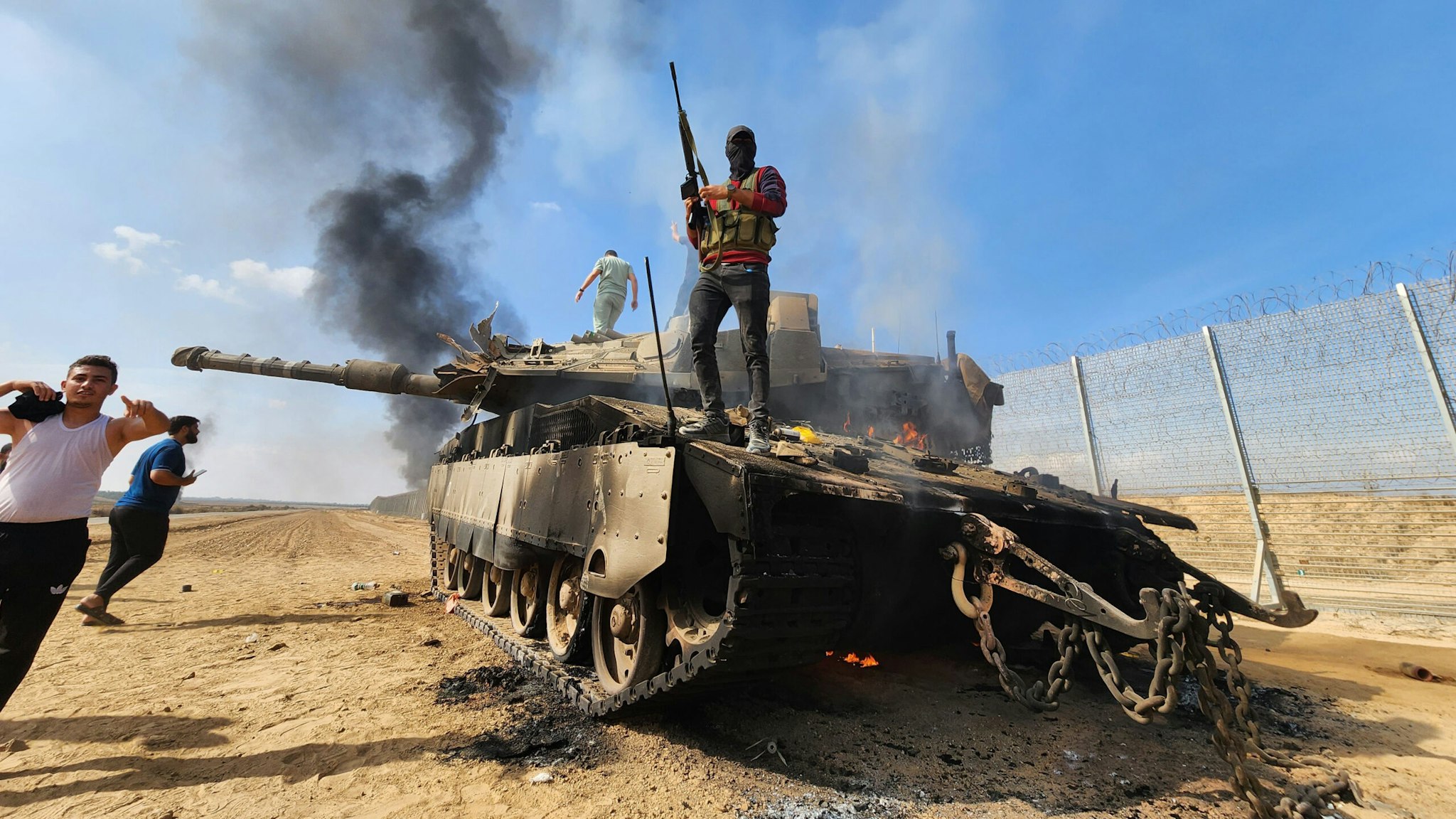 GAZA CITY, GAZA - OCTOBER 07: Hamas' armed wing, the Izz ad-Din al-Qassam Brigades destroy a tank of Israeli forces in Gaza City, Gaza on October 07, 2023.