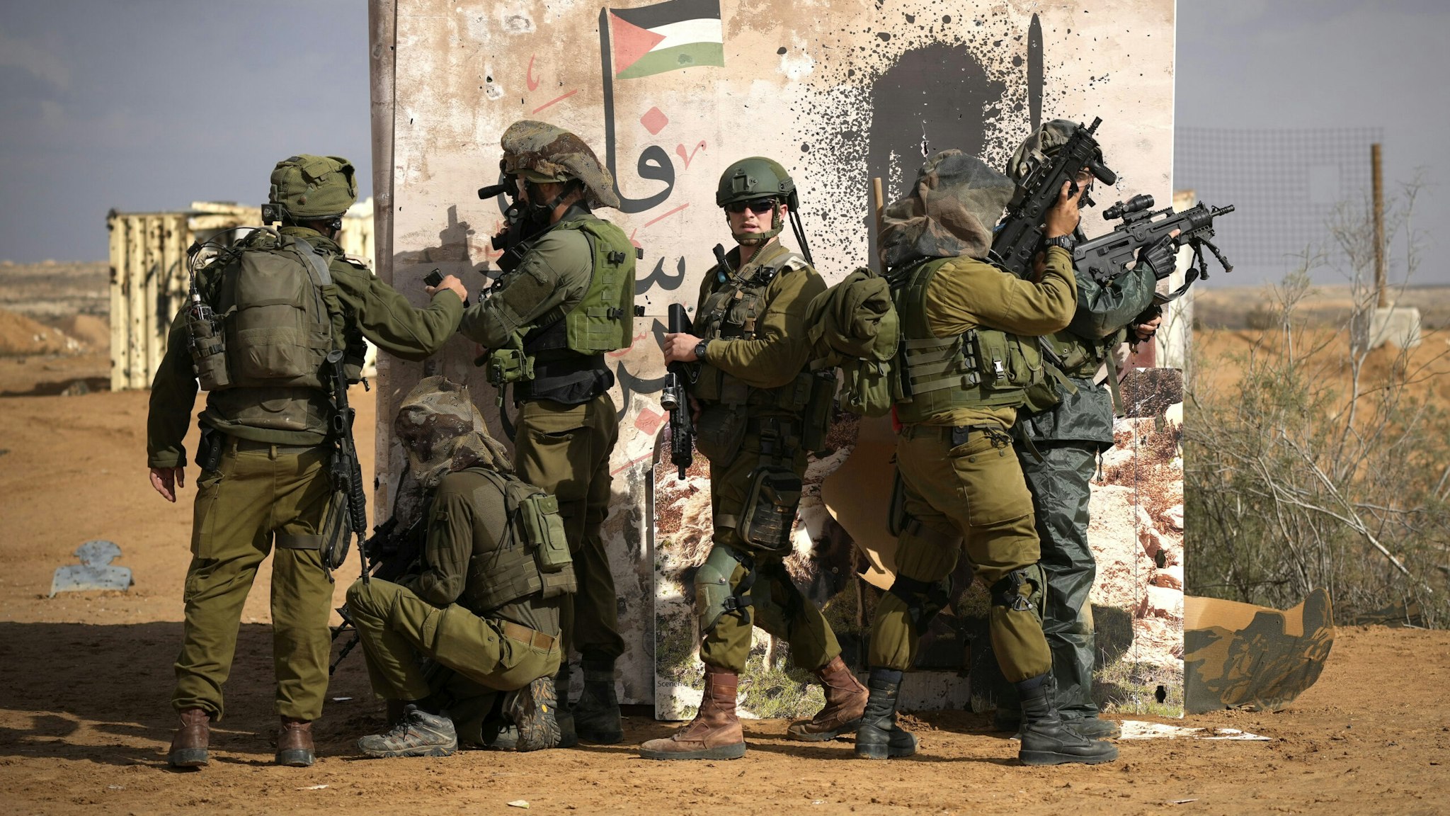 SOUTHERN ISRAEL - NOVEMBER 20: Israeli infantry soldiers take part in a live firing tactical advance exercise near the border in readiness for possible deployment across the border into Gaza on November 20, 2023 in Southern Israel. More than a month after Hamas's Oct. 7 attacks, the country's military has continued its sustained bombardment of the Gaza Strip and launched a ground invasion to vanquish the militant group that governs the Palestinian territory.