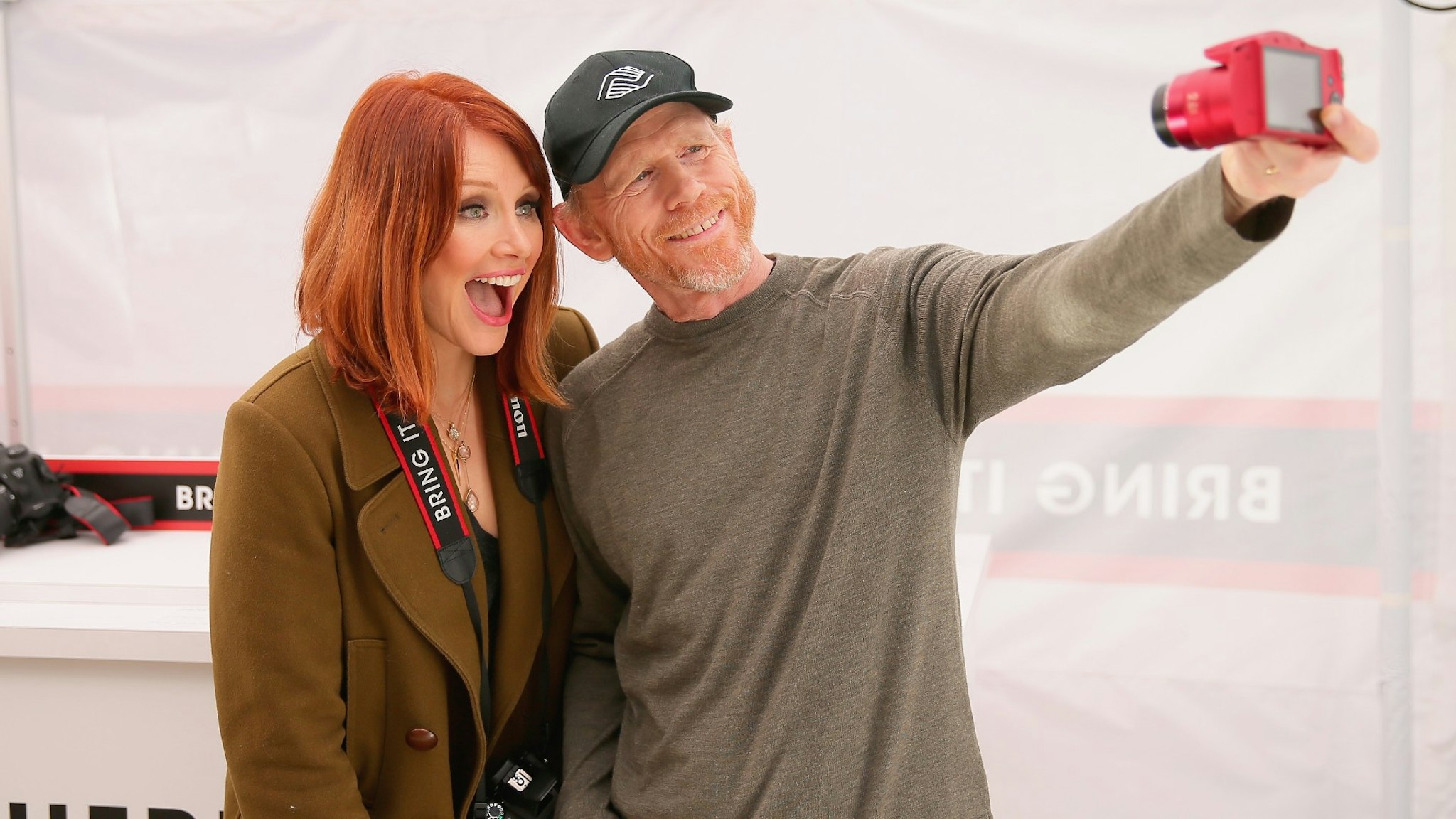 Actress Bryce Dallas Howard, with filmmaker Ron Howard, hosts the Canon Let It Snow Globe spectacle at Hollywood & Highland on December 13, 2014 in Hollywood, California.