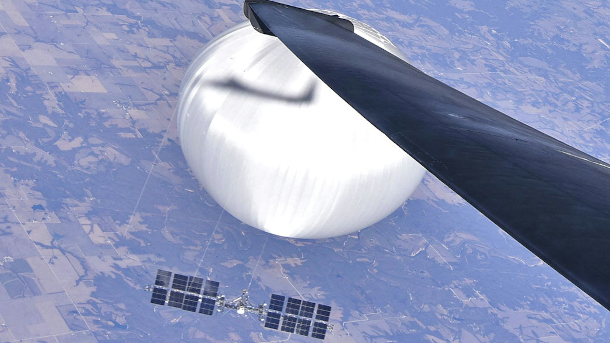 IN FLIGHT - FEBRUARY 3: In this handout image provided by the Department of Defense, a U.S. Air Force U-2 pilot looks down at the suspected Chinese surveillance balloon on February 3, 2023 as it hovers over the Central Continental United States. Recovery efforts began shortly after the balloon was downed.
