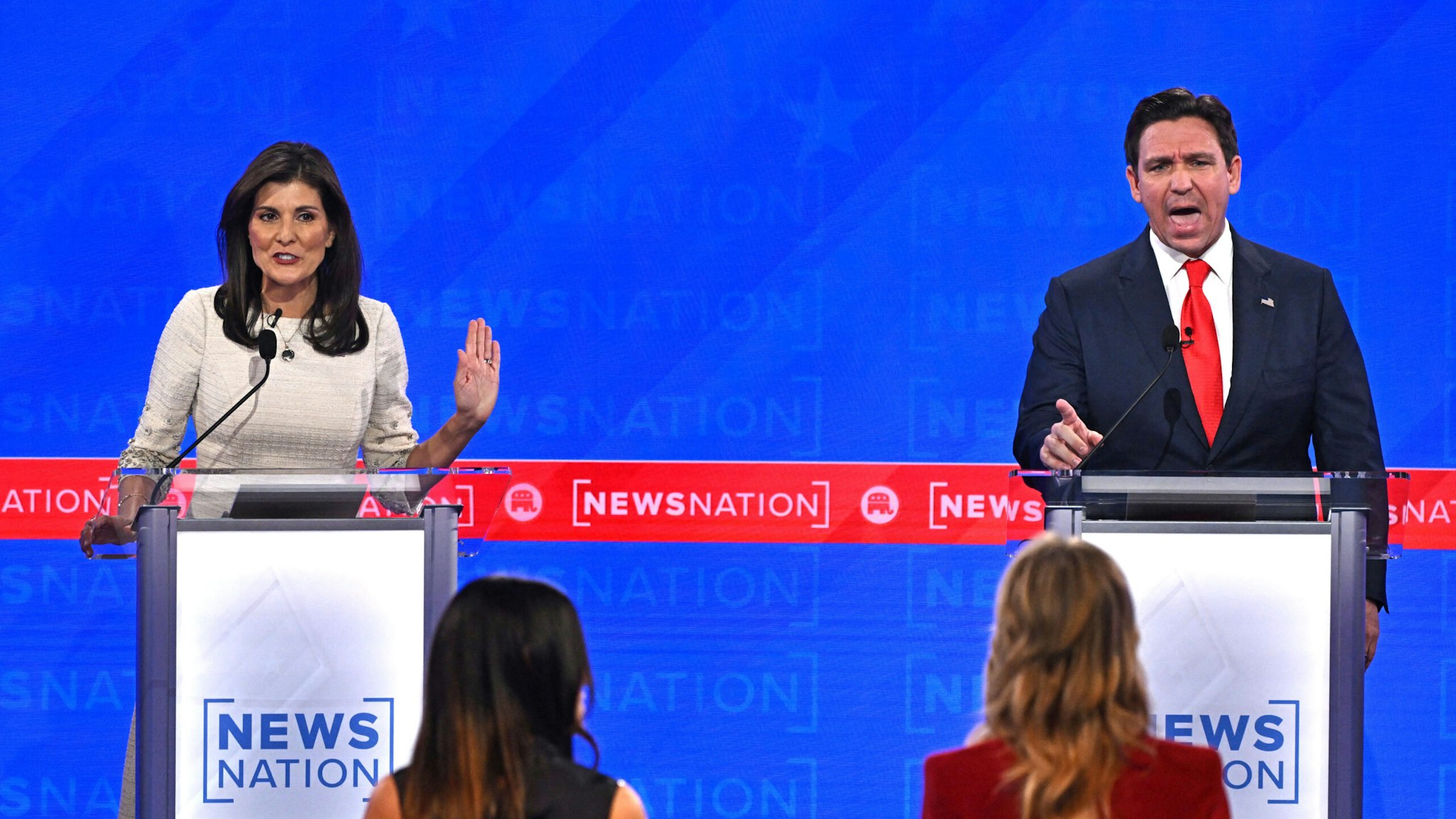 TOPSHOT - Florida Governor Ron DeSantis (R) and former Governor from South Carolina and UN ambassador Nikki Haley gesture as they participate in the fourth Republican presidential primary debate at the University of Alabama in Tuscaloosa, Alabama, on December 6, 2023.