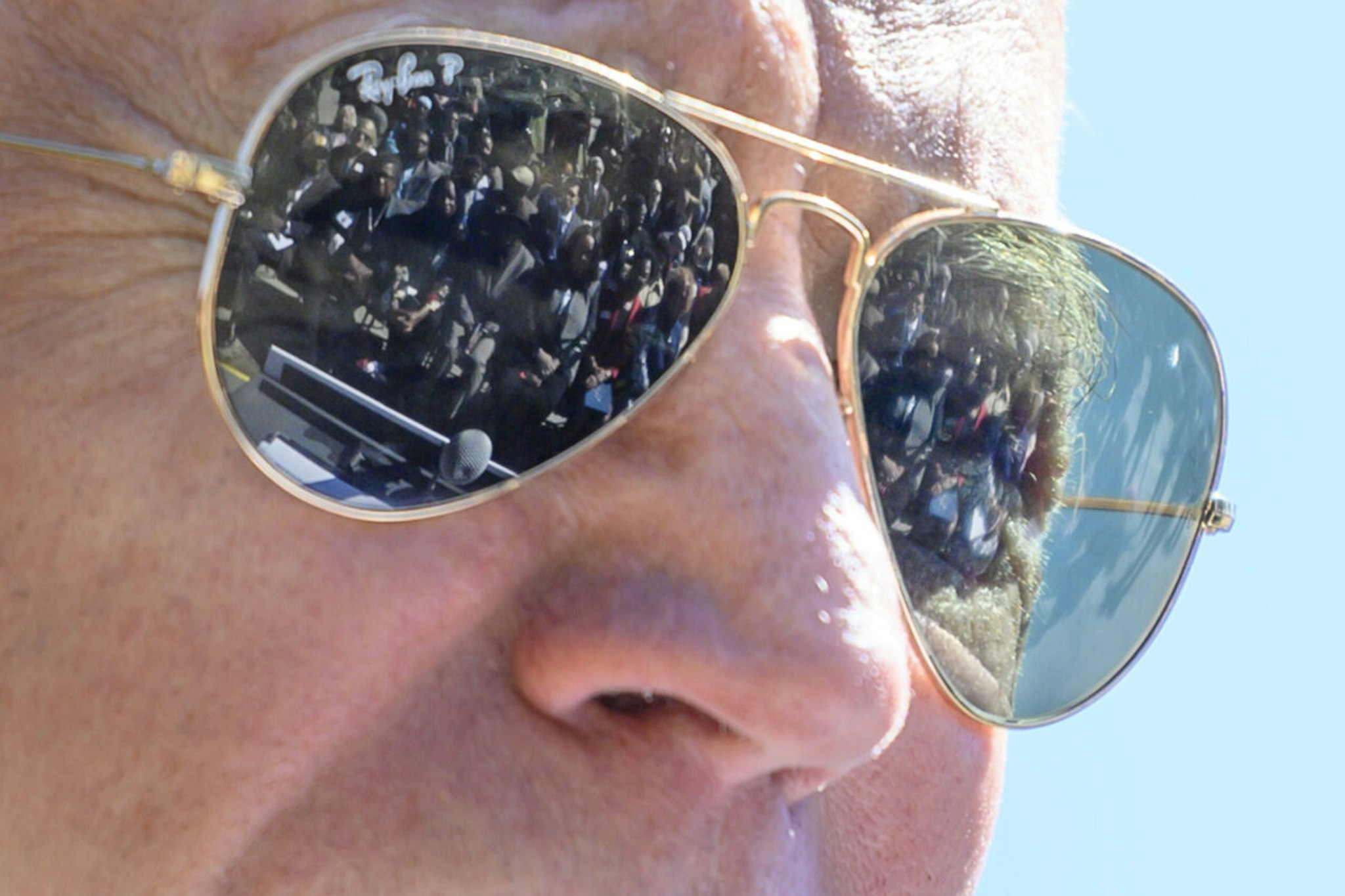 Supporters are reflected in the Ray Ban sunglasses of Democratic presidential candidate Joe Biden as he speaks at St. James Santee Family Health Center during a town hall meeting in McClellanville, SC, on February 27, 2020.