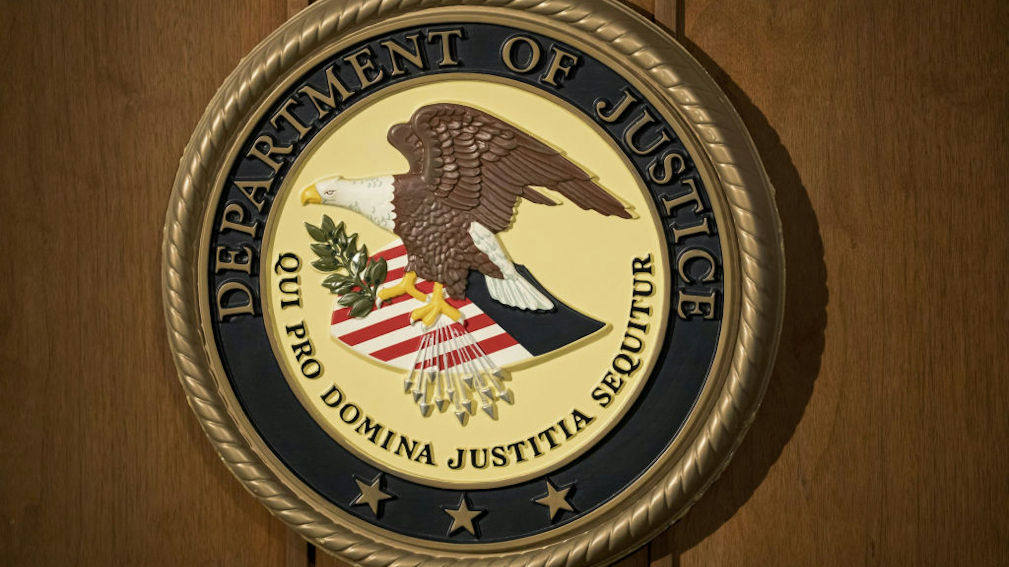 The U.S. Department of Justice seal is displayed on a podium during a news conference at the U.S. Attorney's Office in New York, U.S., on Thursday, July 2, 2020. Ghislaine Maxwell, a longtime associate of disgraced money manager Jeffrey Epstein, was arrested and charged with conspiracy and enticing minors to engage in sex.