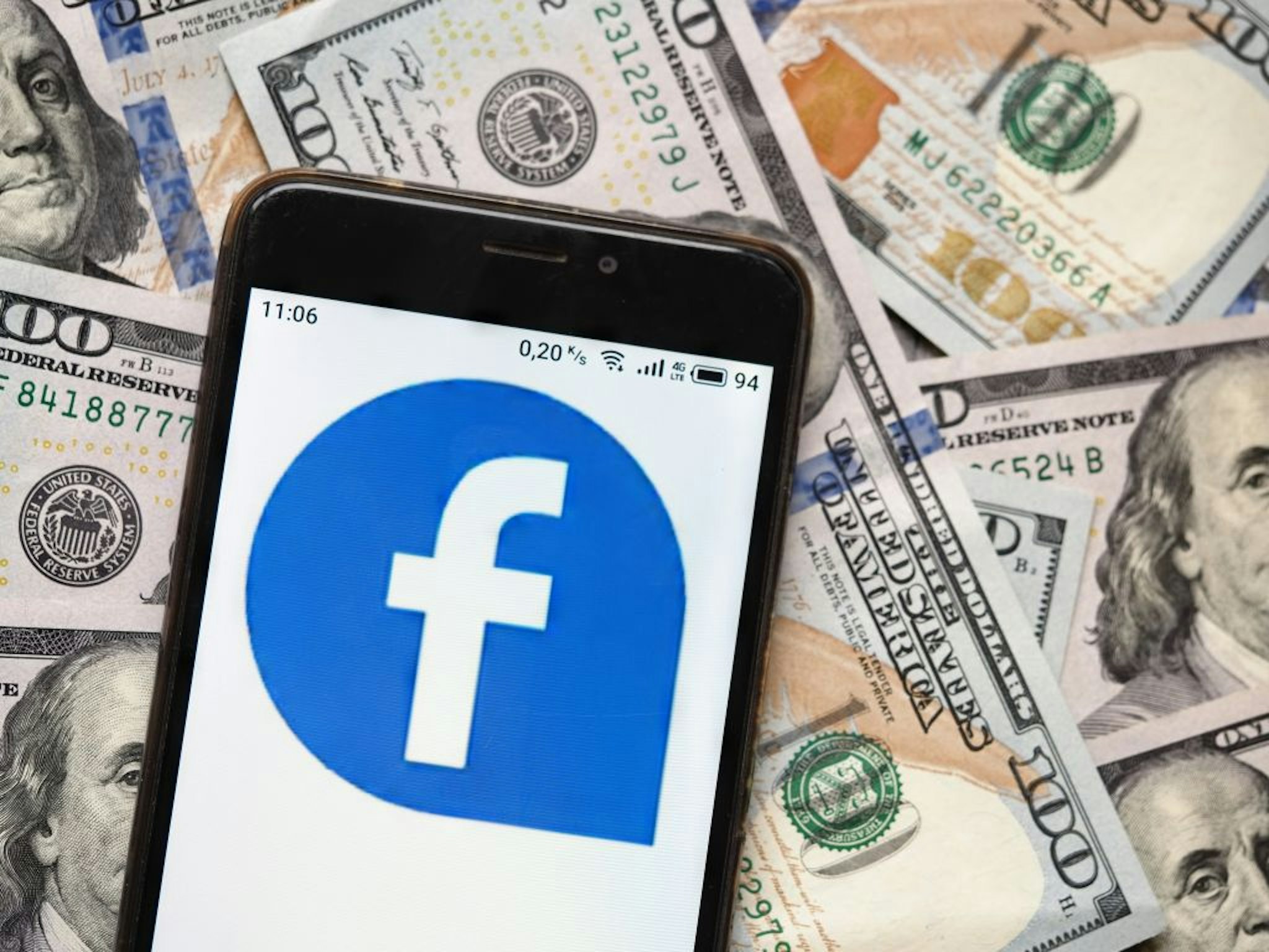 UKRAINE - 2020/09/04: In this photo illustration a Facebook logo seen displayed on a smartphone with 100 dollar bills in the background. (Photo Illustration by Igor Golovniov/SOPA Images/LightRocket via Getty Images)