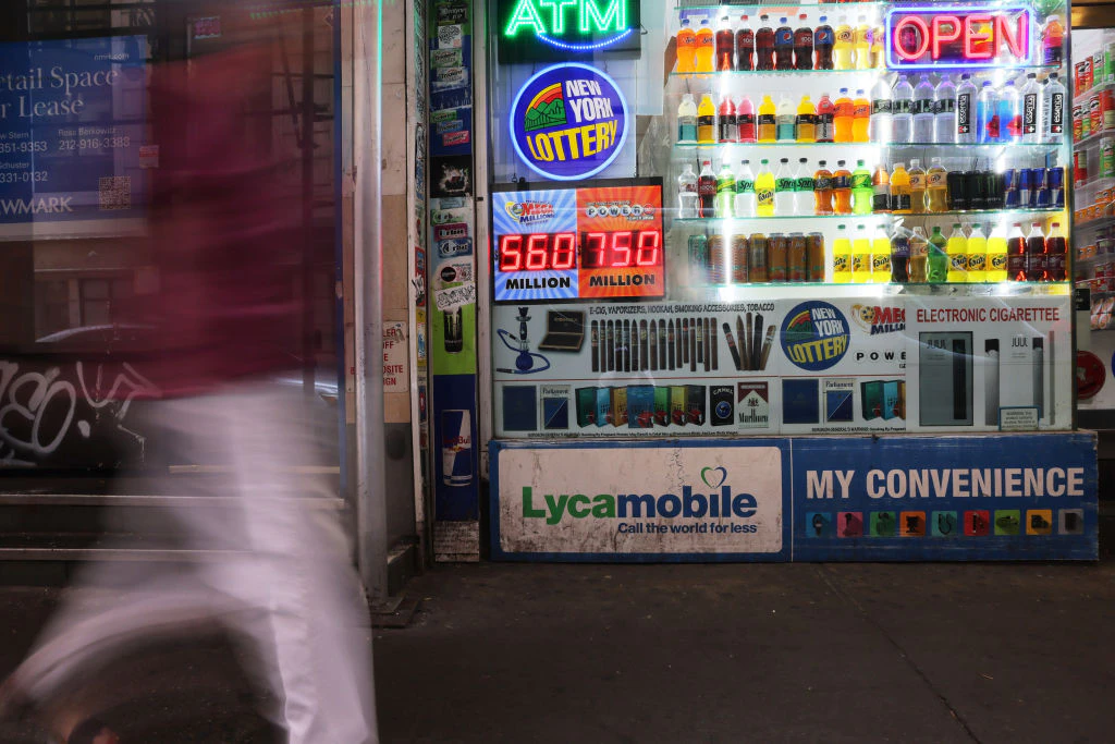 NEW YORK, NEW YORK - JULY 12: A Powerball and Mega Millions lottery advertisement is displayed at a convenience store on July 12, 2023 in New York City. The Powerball jackpot reached an estimated $725 million for the next drawing with a cash option for the jackpot at an estimated $366 million. The current jackpot, which is played in 45 states, as well as Washington, D.C., Puerto Rico and the U.S. Virgin Islands, has been growing since mid-April after a $252.6 million prize was won in Ohio. (Photo by Michael M. Santiago/Getty Images)