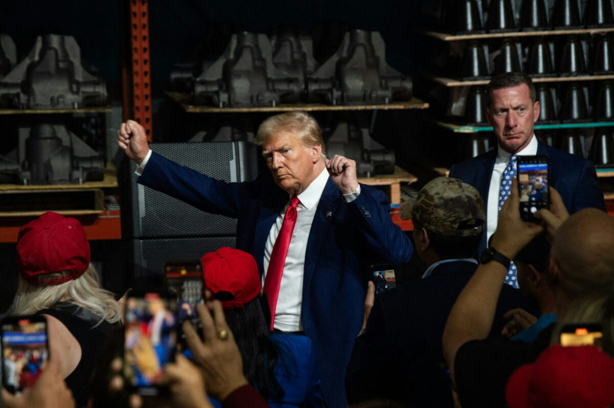 Former US President and 2024 presidential hopeful Donald Trump gestures while speaking at Drake Enterprises, an automotive parts manufacturer and supplier, in Clinton, Michigan, on September 27, 2023.