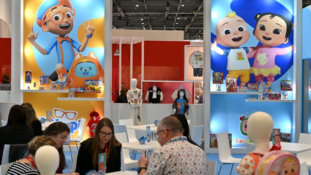 LONDON, ENGLAND - OCTOBER 04: Posters showing Blippi and Cocomelon Characters is displayed at the Moonbug Entertainment stand during the Brand Licensing Europe at ExCel on October 04, 2023 in London, England. Brand Licensing Europe (BLE) event is dedicated to licensing and brand extension, bringing together retailers, licensees and manufacturers for three days of deal-making, networking and trend spotting.