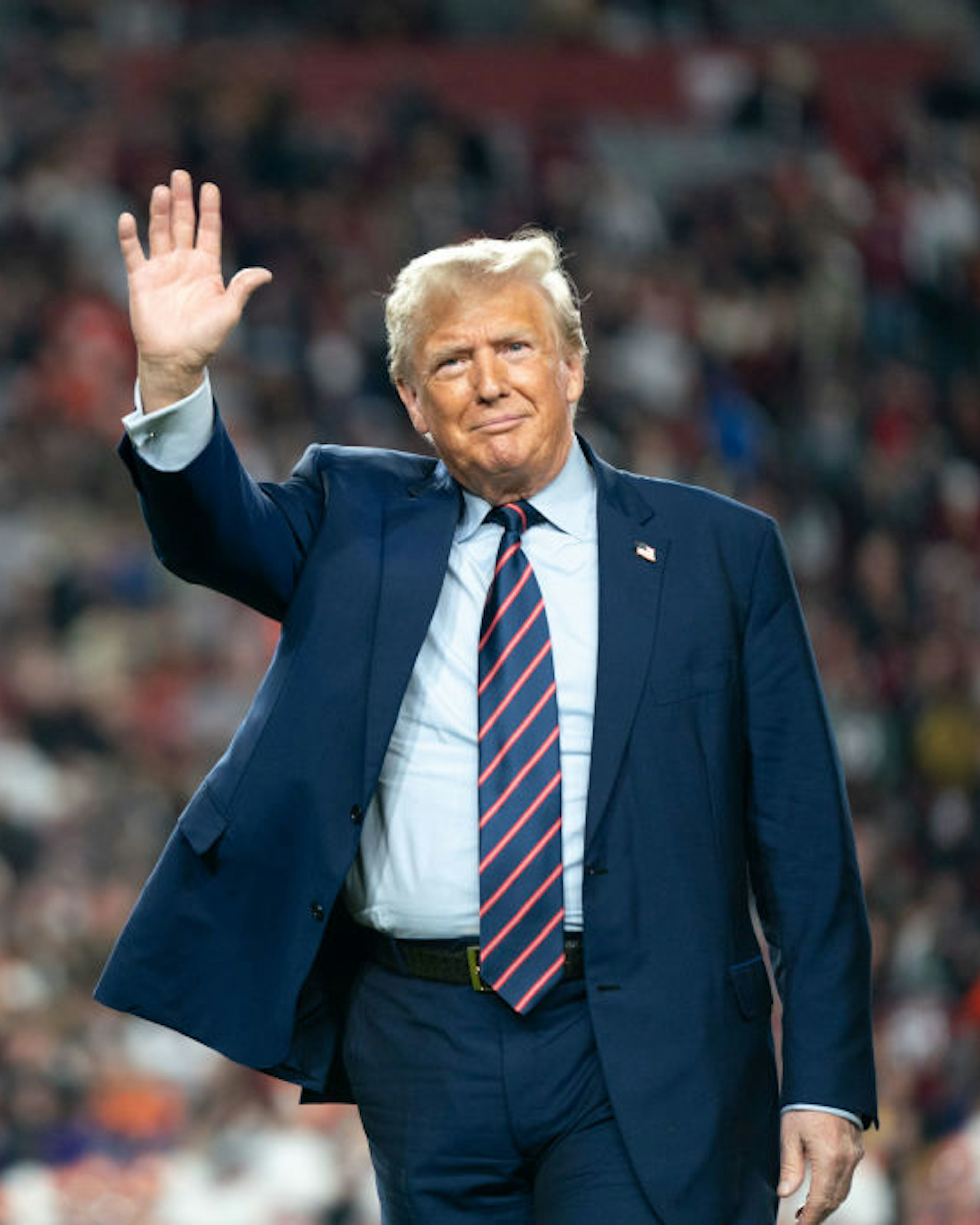 COLUMBIA, SOUTH CAROLINA - NOVEMBER 25: Former U.S. President Donald Trump waves to the crowd on the field during halftime in the Palmetto Bowl between Clemson and South Carolina at Williams Brice Stadium on November 25, 2023 in Columbia, South Carolina. Trump attended the rivalry game in a key early-voting state as he campaigns ahead of next year’s Republican presidential primary. (Photo by Sean Rayford/Getty Images)