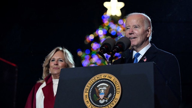 TOPSHOT - US President Joe Biden speaks as First Lady Jill Biden looks on during the National Christmas tree lighting ceremony on the Ellipse of the White House in Washington, DC, on November 30, 2023. (Photo by ANDREW CABALLERO-REYNOLDS / AFP) (Photo by ANDREW CABALLERO-REYNOLDS/AFP via Getty Images)