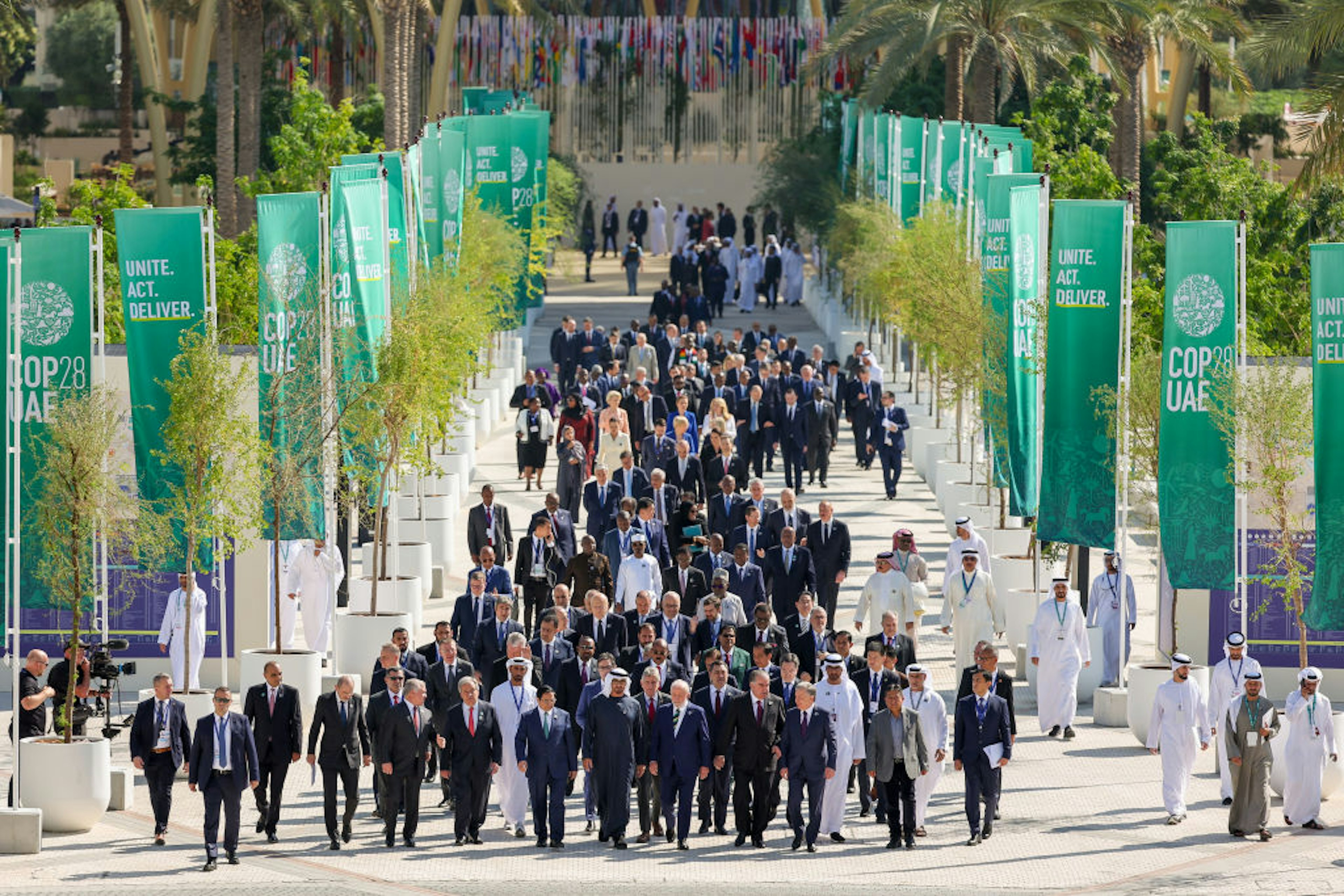 DUBAI, UNITED ARAB EMIRATES - DECEMBER 1: In this handout image provided by COP28, world leaders walk down Al Wasl avenue following a family photo during day one of the high-level segment of the UNFCCC COP28 Climate Conference at Expo City Dubai on December 1, 2023 in Dubai, United Arab Emirates. The COP28, which is running from November 30 through December 12, brings together stakeholders, including international heads of state and other leaders, scientists, environmentalists, indigenous peoples representatives, activists and others to discuss and agree on the implementation of global measures towards mitigating the effects of climate change. (Photo by Neville Hopwood/COP28 via Getty Images)